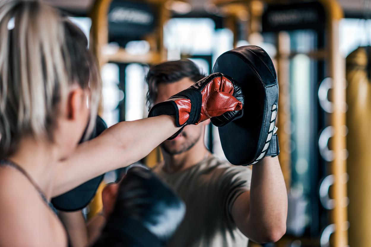 Woman boxing with trainer